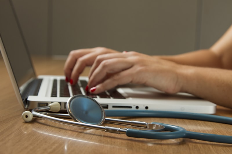 Stethoscope beside a laptop &mdash; homoeopathy consultation